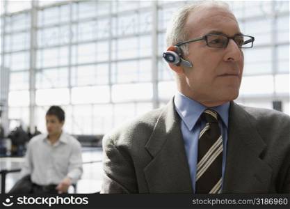 Close-up of a businessman wearing a hands free device at an airport