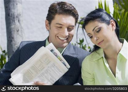 Close-up of a businessman with a businesswoman and smiling