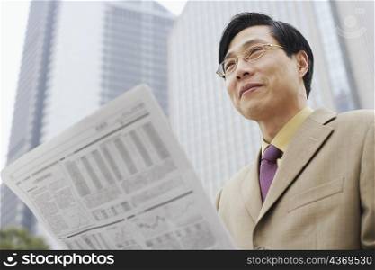 Close-up of a businessman with a newspaper