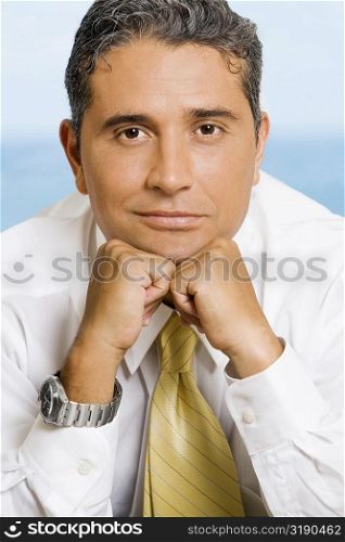 Close-up of a businessman with his hands on his chin