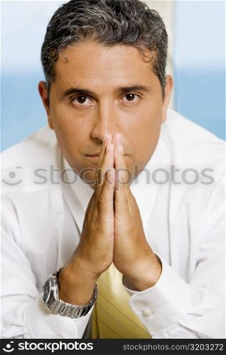 Close-up of a businessman with his hands together