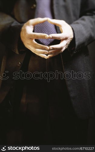 Close-up of a businessman with his hands together