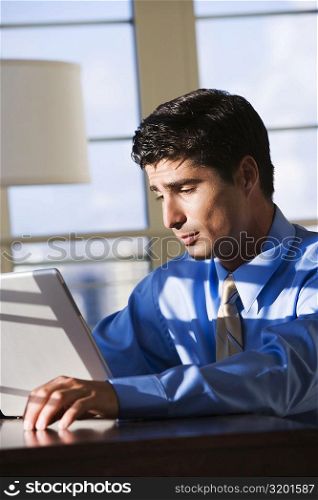 Close-up of a businessman working on a laptop