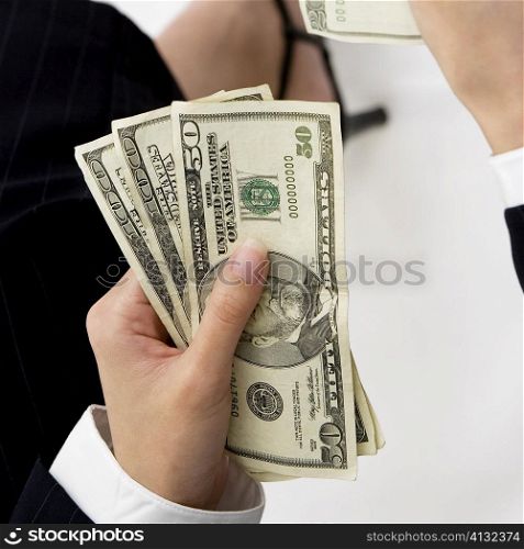 Close-up of a businesswoman&acute;s hand holding American dollar bills