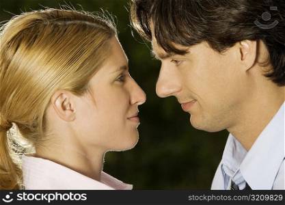 Close-up of a businesswoman and a businessman looking at each other