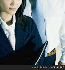 Close-up of a businesswoman and a businessman standing together