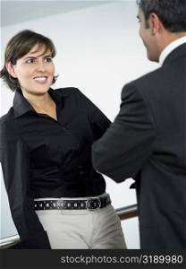 Close-up of a businesswoman and a businessman talking to each other