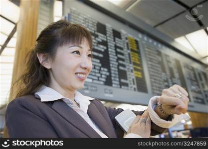 Close-up of a businesswoman at an airport and smiling
