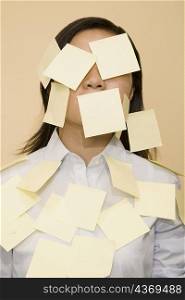 Close-up of a businesswoman covered with adhesive notes