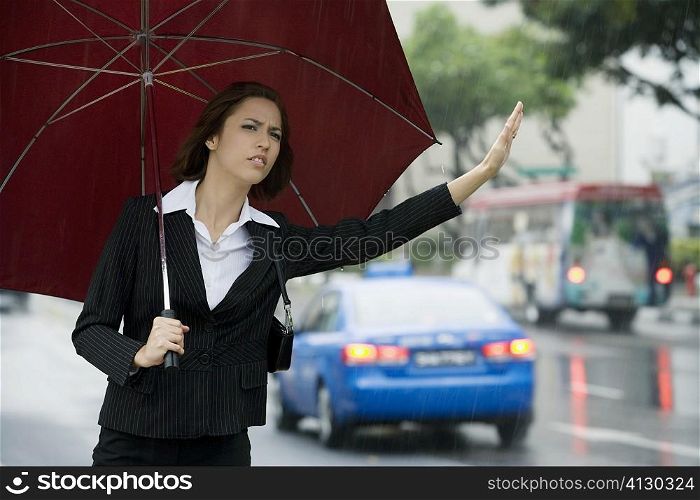 Close-up of a businesswoman hailing for a vehicle