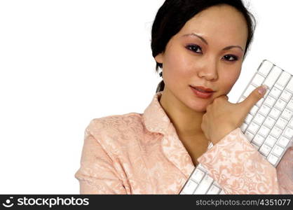 Close-up of a businesswoman holding a computer keyboard