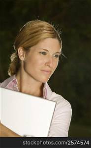 Close-up of a businesswoman holding a laptop