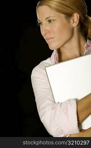 Close-up of a businesswoman holding a laptop