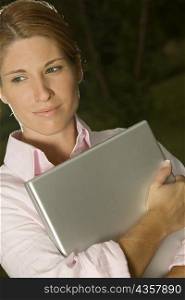 Close-up of a businesswoman holding a laptop