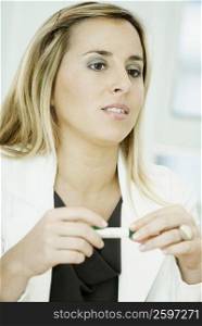 Close-up of a businesswoman holding a pen