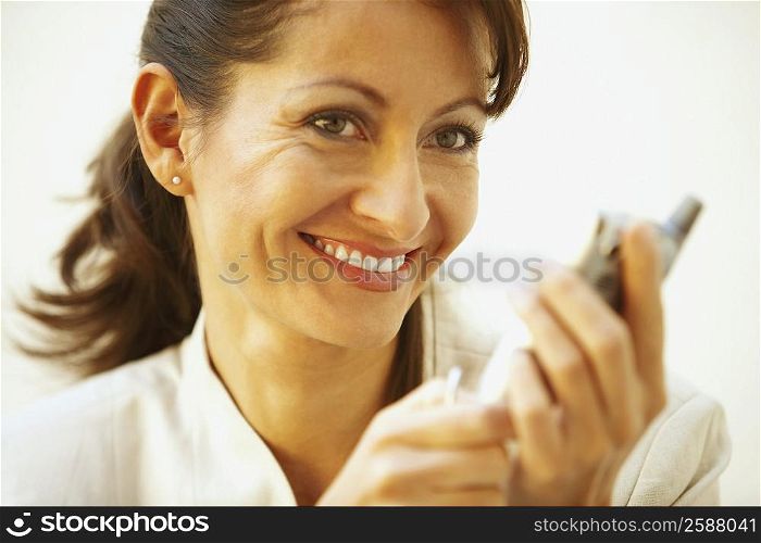 Close-up of a businesswoman holding a personal data assistant