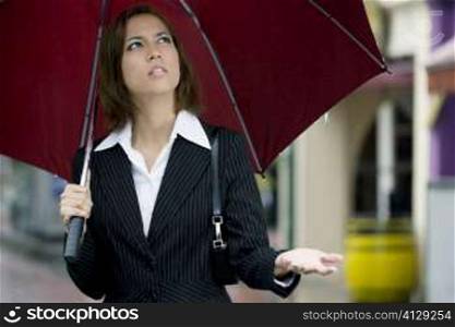 Close-up of a businesswoman holding an umbrella