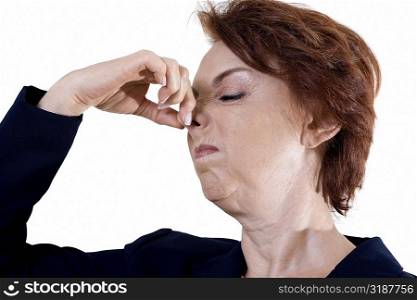 Close-up of a businesswoman holding her nose