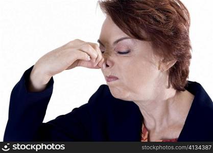 Close-up of a businesswoman holding her nose