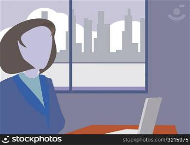 Close-up of a businesswoman in front of a laptop