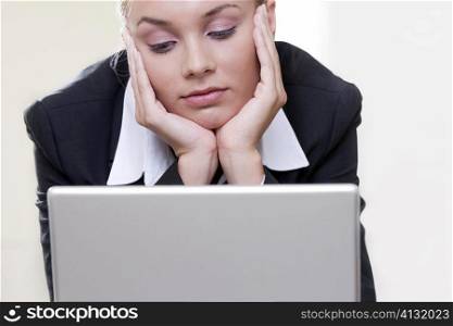 Close-up of a businesswoman in front of a laptop