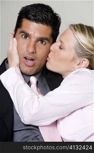 Close-up of a businesswoman kissing a businessman