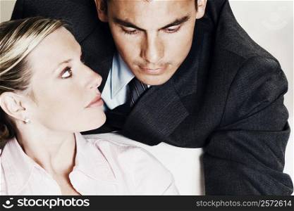 Close-up of a businesswoman looking at a businessman