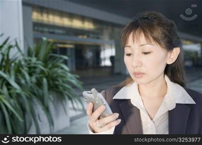 Close-up of a businesswoman looking at a mobile phone
