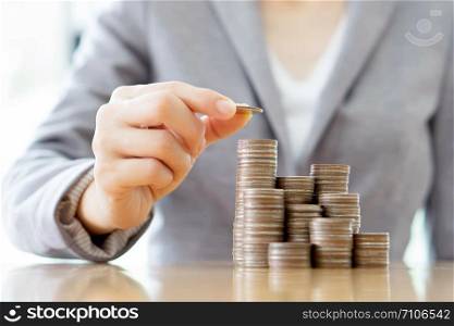 Close-up Of A Businesswoman Making Stack Of Coins