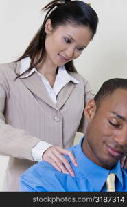 Close-up of a businesswoman massaging a businessman&acute;s shoulders