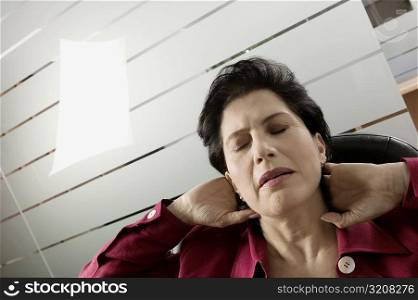 Close-up of a businesswoman massaging her neck
