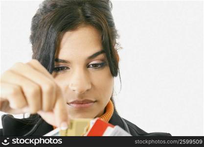 Close-up of a businesswoman picking a credit card