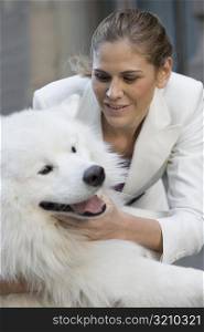 Close-up of a businesswoman playing with her dog