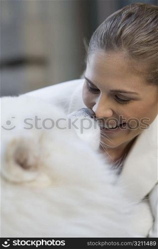 Close-up of a businesswoman playing with her dog