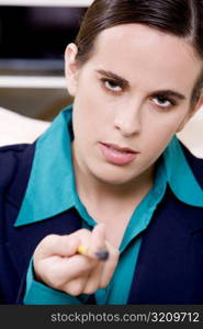 Close-up of a businesswoman pointing with a pen