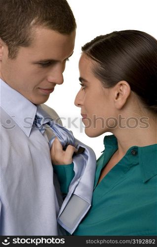 Close-up of a businesswoman pulling a businessman&acute;s tie