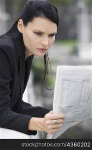 Close-up of a businesswoman reading a newspaper