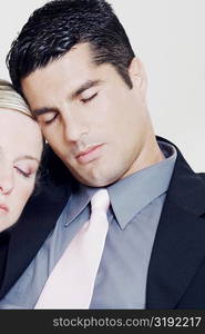 Close-up of a businesswoman resting her head on a businessman&acute;s shoulder