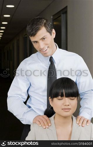 Close-up of a businesswoman rubbing a businesswoman&acute;s shoulders