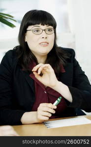 Close-up of a businesswoman sitting at a table