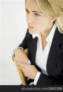 Close-up of a businesswoman sitting on a chair and looking away