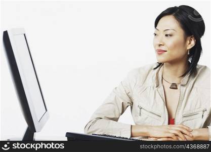 Close-up of a businesswoman smiling near a computer