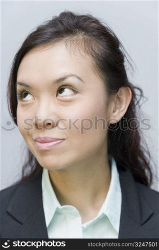 Close-up of a businesswoman smirking