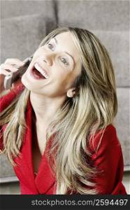 Close-up of a businesswoman talking on a mobile phone and laughing