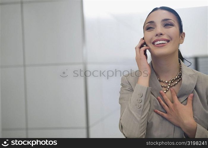 Close-up of a businesswoman talking on a mobile phone and smiling