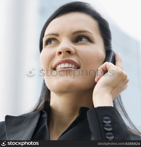 Close-up of a businesswoman talking on a mobile phone and smiling