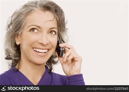 Close-up of a businesswoman talking on a mobile phone and thinking
