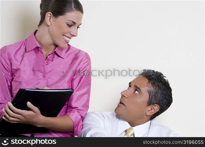 Close-up of a businesswoman talking to a businessman