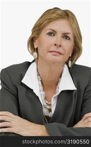 Close-up of a businesswoman thinking with her arms crossed