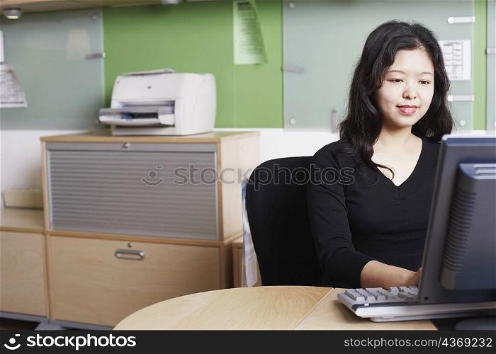 Close-up of a businesswoman using a computer smiling